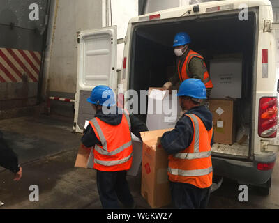 Chinese police officers unload 2,333 cartons of counterfeit Zhonghua brand cigarettes seized during a winter operation in Zhenjiang city, east China's Stock Photo