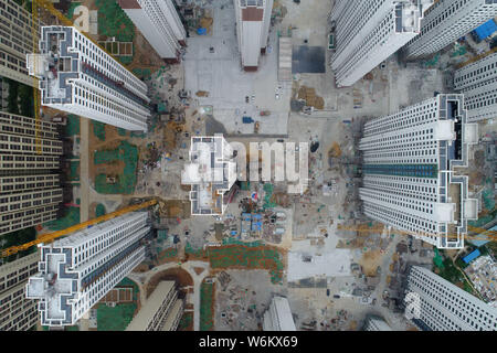 --FILE--Aerial view of high-rise buildings of a residential property project under construction in Xiangyang city, central China's Hubei province, 28 Stock Photo