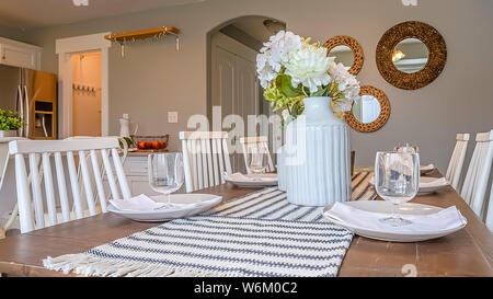 Panorama frame Dining room interior with brown wooden table and white wooden chairs Stock Photo