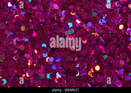 Saturated purple background with vivid confetti. Lilac glitter texture on macro. High resolution photo. Stock Photo