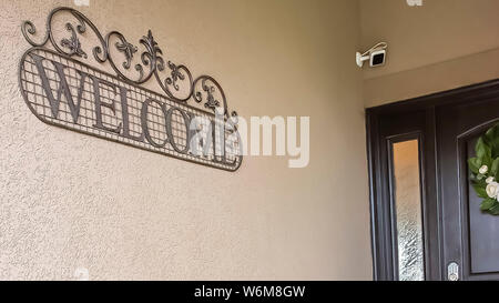 Panorama frame Rustic metal and wood bench with red pillow on the porch of a home Stock Photo