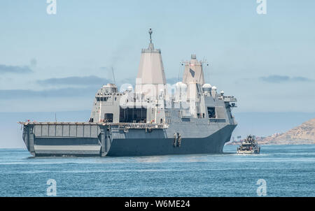 190729-N-NT795-112 SAN DIEGO (July 29, 2019) Sailors assigned to Coastal Riverine Squadron 3 aboard Mark VI patrol boat, commences approach alongside amphibious transport dock ship USS San Diego (LPD 22) to conduct personnel transfer during a high value asset security exercise as part of unit level training conducted by Coastal Riverine Group 1 training evaluation unit. The Coastal Riverine Force is a core Navy capability that provides port and harbor security, high value asset security, and maritime security operation in the coastal and inland waterways. (U.S. Navy photo by Chief Boatswain’s Stock Photo