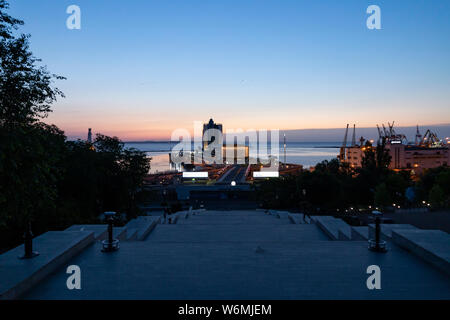 Ukraine, Odessa, Primorsky Boulevard, 13th of June 2019. View down the Potemkin Stairs on the seaport and the Hotel Odessa at dawn. Stock Photo