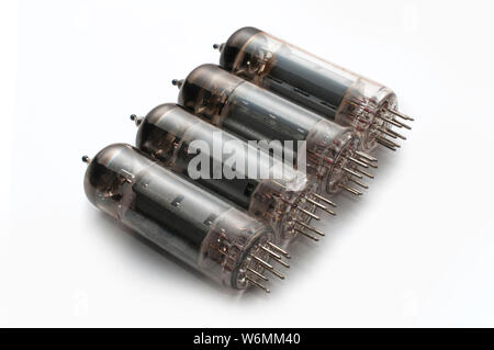 Set of four guitar amplifier power tubes on white background Stock Photo