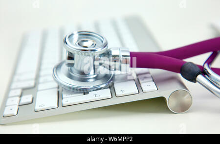 Stethoscope lying on a table on an open book. Stock Photo
