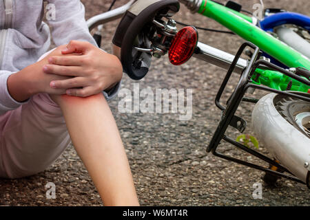 Child in pain after a bicycle accident. Kids safety concept Stock Photo