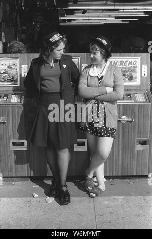 Blackpool teenage girls on holiday wearing Kiss Me Quick, Squeeze Me Slow hat hats 1970s working class young women 1974 1970s UK  HOMER SYKES Stock Photo