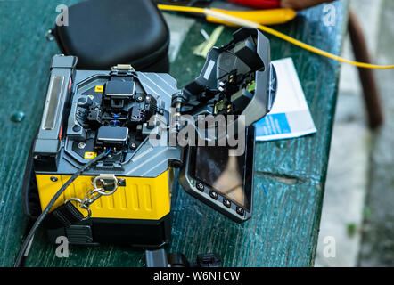 Device for mounting optical cable. Optical internet Technology concept. Optical fiber assembly. Stock Photo