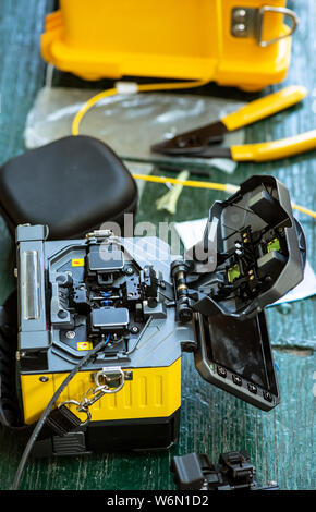 Device for mounting optical cable. Optical internet Technology concept. Optical fiber assembly. Stock Photo