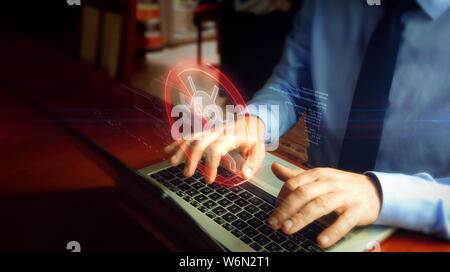 Man typing on laptop with antivirus hologram screen over keyboard. Computer protection, cyber security and internet safety concept. Stock Photo