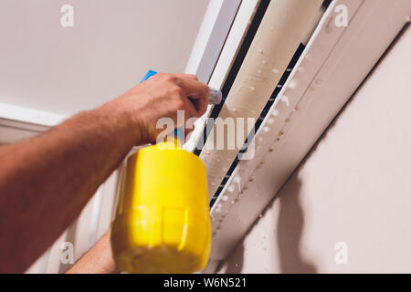 Male technician cleaning air conditioner indoors. service Stock Photo