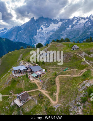 Aerial view of the Bertone Refuge, Mont Chetif and Mont Blanc during a cloudy sunset. Mont de la Saxe, Courmayeur, Aosta Valley, northern Italy, South Stock Photo