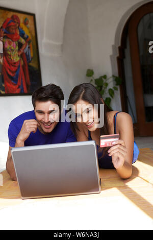 Couple doing online shopping with a credit card Stock Photo