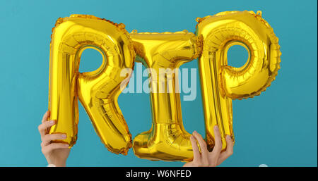 Golden RIP words made of inflatable balloons Stock Photo