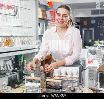 Glad woman consumer with set for salt and pepper in the tableware store Stock Photo