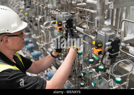 service engineer checks an pneumatic valve Stock Photo