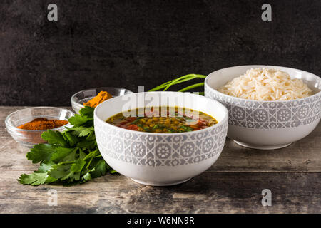 Indian lentil soup dal (dhal) in a bowl on wooden table. Stock Photo