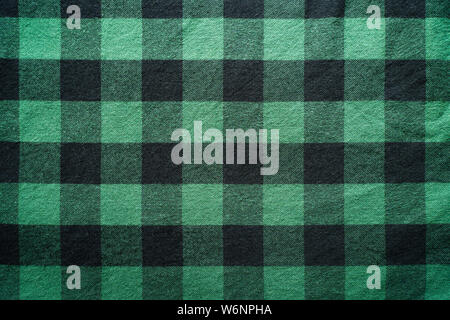Fabric in a cage. Black and green square pattern. Clothes Empty Background Stock Photo