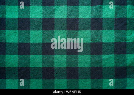Fabric in a cage. Black and green square pattern. Clothes Empty Background Stock Photo
