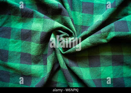 Fabric in a cage. Black and green square pattern. Crumpled Cloth Blank Background Stock Photo