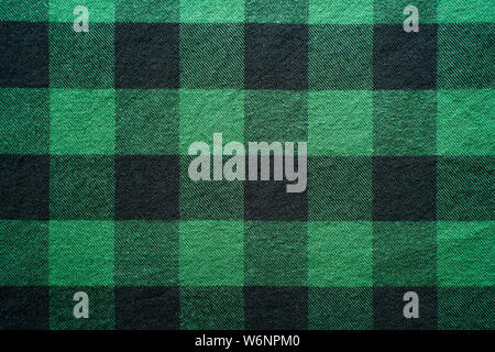 Fabric in a cage. Black and green square pattern. Clothes Empty Background Stock Photo