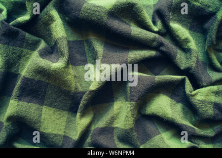 Fabric in a cage. Black and green square pattern. Crumpled Cloth Blank Background Stock Photo