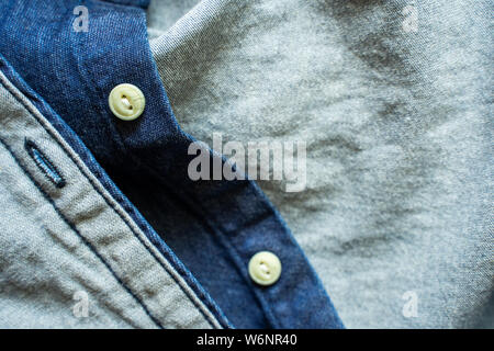 Blue denim shirt with white buttons close-up. Garment background Stock Photo