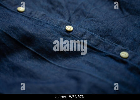 Blue denim shirt with white buttons close-up. Garment background Stock Photo