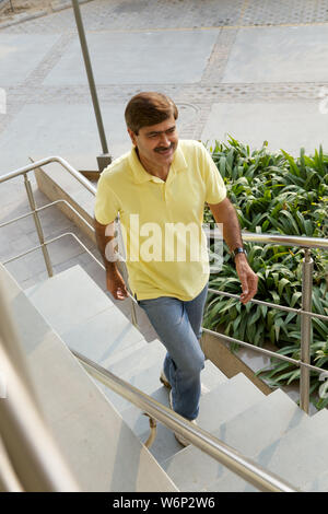 Man climbing up stairs Stock Photo