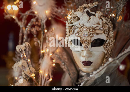 Venetian Masks standing and displaying their costumes in the Ca’ Rezzonico Stock Photo