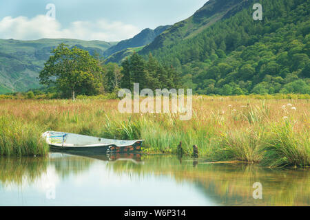 A boat moored on Crummock Water in the English Lake District National Park. UK Stock Photo
