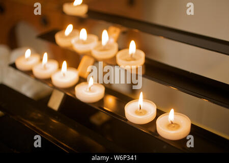 Candles lighting in Catholic church Stock Photo