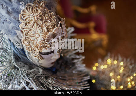 Venetian Masks standing and displaying their costumes in the Ca’ Rezzonico Stock Photo