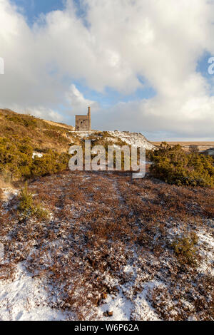 Wheal Betsy, the old mining engine house remains on Dartmoor National Park, Devon in the snow Stock Photo