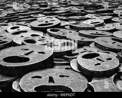 Close-up of steel faces in the artwork Shalekhet (Fallen Leaves), Jewish Museum, Berlin, Germany Stock Photo