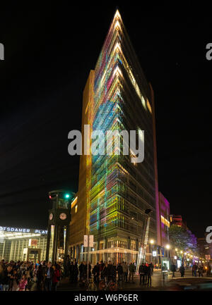 The building Potsdamer Platz 11, Berlin, Germany, illuminated with colourful light display during the Festival of Light Stock Photo