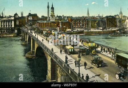 London Bridge, c1910. View of horse-drawn buses on London Bridge, looking towards the City from Southwark. On the left of the bridge is Fishmongers' Hall, with the Monument and church of St Magnus the Martyr in the centre. Postcard. Stock Photo