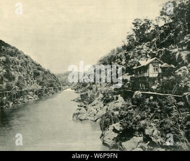 'Cataract Gorge, from the Bridge, Launceston', 1901. The earliest known European visitor to Cataract iver gorge on the South Esk River in Launceston, Tasmania, was William Collins, who discovered its entrance in 1804. From &quot;Federated Australia&quot;. [The Werner Company, London, 1901] Stock Photo