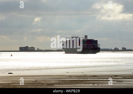 Low tide with sandbars visible at the Wester Schelde while a container ship passes over the Western Scheldt on its way to the North Sea, the Netherlan Stock Photo