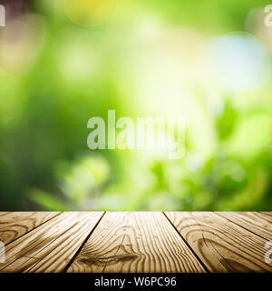 Empty wooden table with garden bokeh background. Summer outdoors theme, template mockup Stock Photo