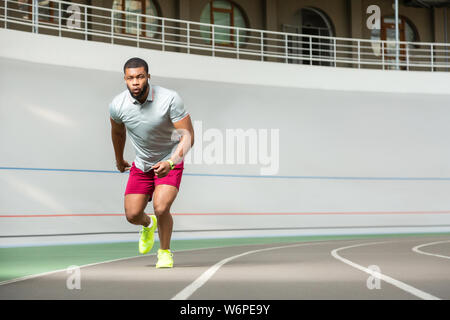 Energetic professional young male runner in stylish sneakers Stock Photo