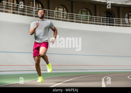 Determined healthy young man jogging in the morning Stock Photo