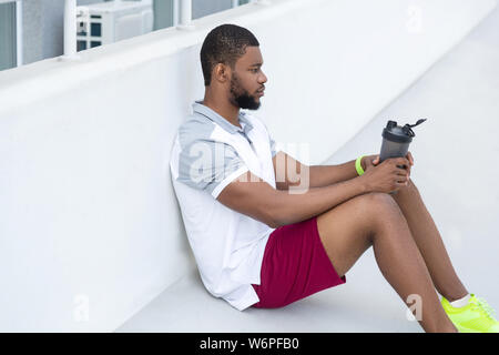 Handsome dark-haired young sportsman looking into the distance Stock Photo