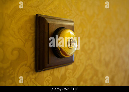 Old fashioned brass light switch Stock Photo
