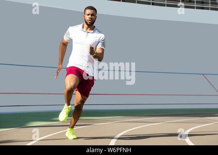 Purposeful healthy young male runner jogging in sportswear Stock Photo