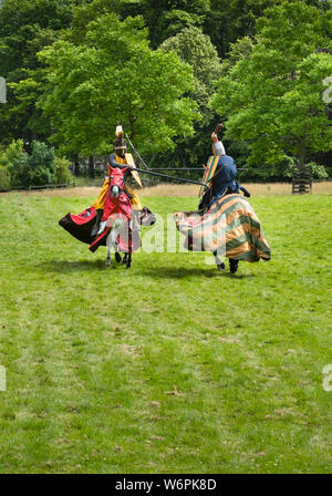 Mounted knights in medieval armour fighting on horseback during jousting demonstration Stock Photo