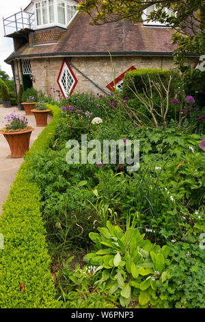 View of the outside exterior of A La Ronde – an 18th-century 16-sided house located near Lympstone, Exmouth, Devon UK – from outside / the gardens with mixed flower border. (110) Stock Photo