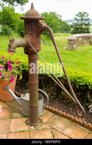 A traditional old / early / vintage (most probably Victorian or Edwardian era) hand pump water pump in the garden of an 18th-century house near, Exmouth in Devon, UK. (110) Stock Photo