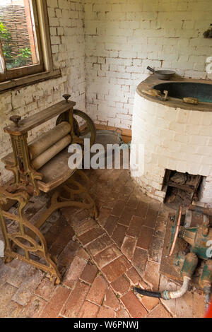 A Victorian era laundry in an 18th-century house near, Exmouth, Devon UK. Water in the main tub was heated by fire, and clothes were rung out in the mangle wringer rollers. (110) Stock Photo