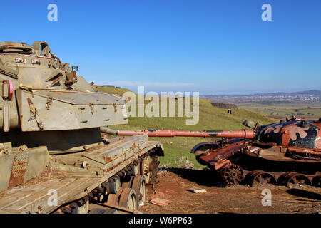 Two IDF army tanks sit at the Oz 77 Memorial overlooking a tank on a hill in the Valley of Tears. Stock Photo